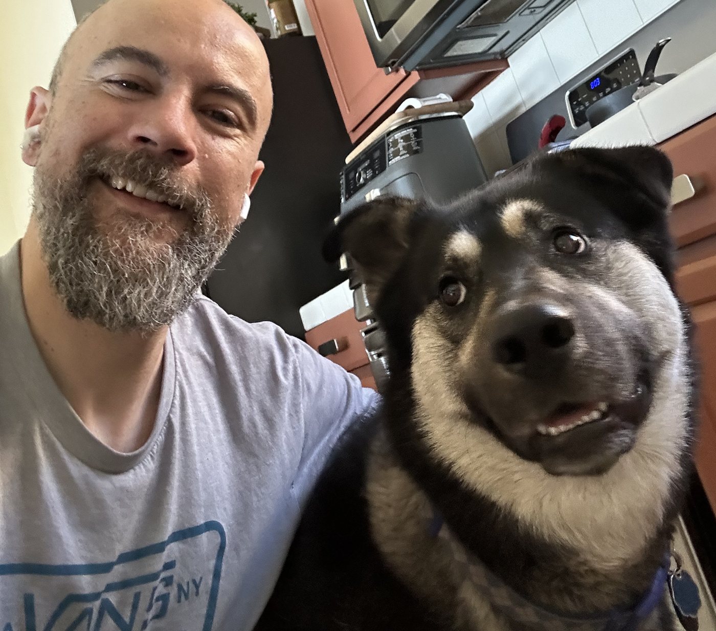 Fred Jabre smiling with his husky, Falcor, at home in California
